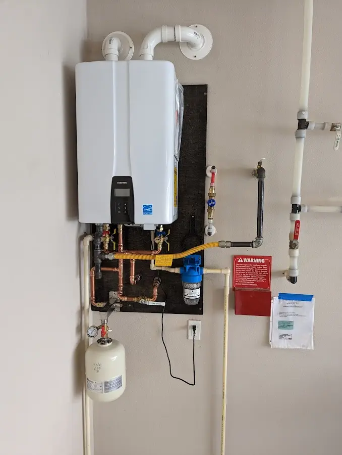 Professional plumber installing copper piping in a Greenport home